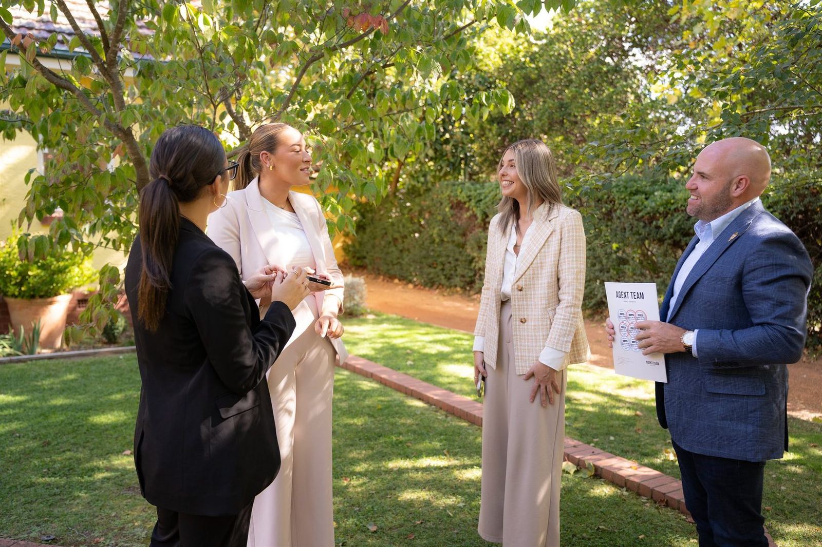 The Agent Team sales team meeting outdoors in a Canberra garden